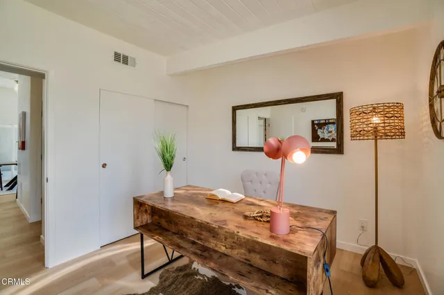 a bedroom with a large window and a bed