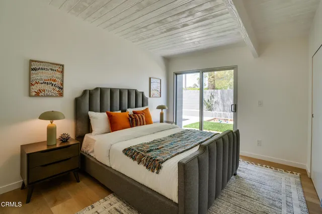 a view of a hallway with wooden floor and stairs