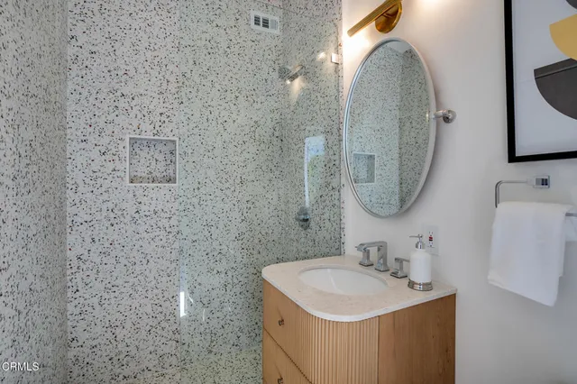 a bedroom with a bed and large window