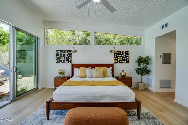 a view of a house with potted plants