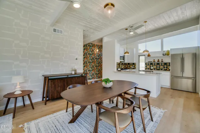 a living room with furniture a clock and a window