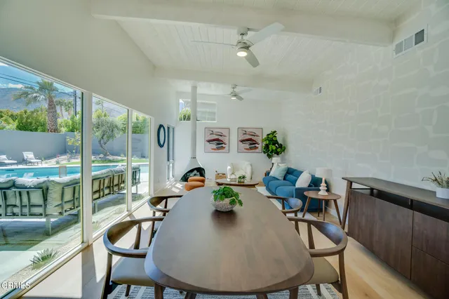 a living room with furniture and wall painting