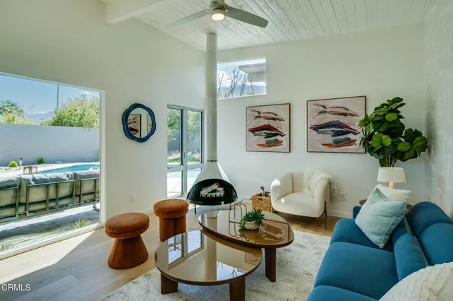 a living room with furniture and a clock