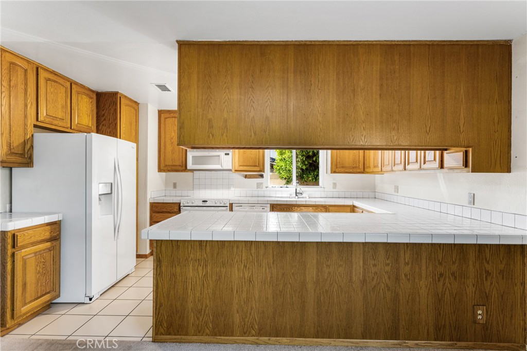 3288 Arizona Lane Costa Mesa, CA 92626 - Photo 12 of 33 a kitchen with a sink a refrigerator and a stove