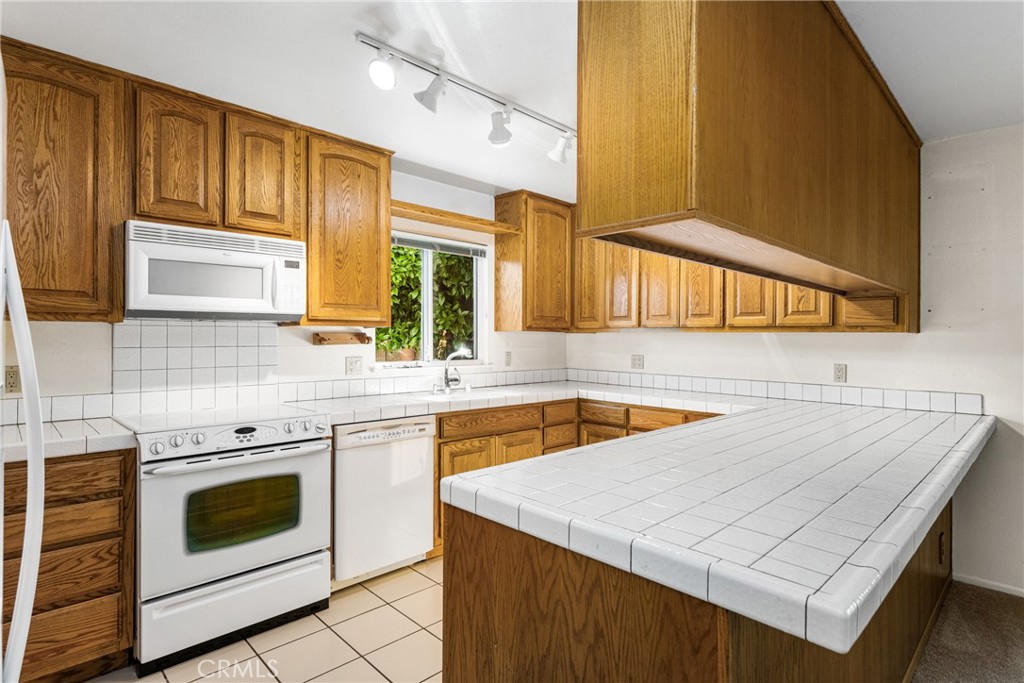 3288 Arizona Lane Costa Mesa, CA 92626 - Photo 14 of 33 a kitchen with stainless steel appliances a stove a sink and a microwave
