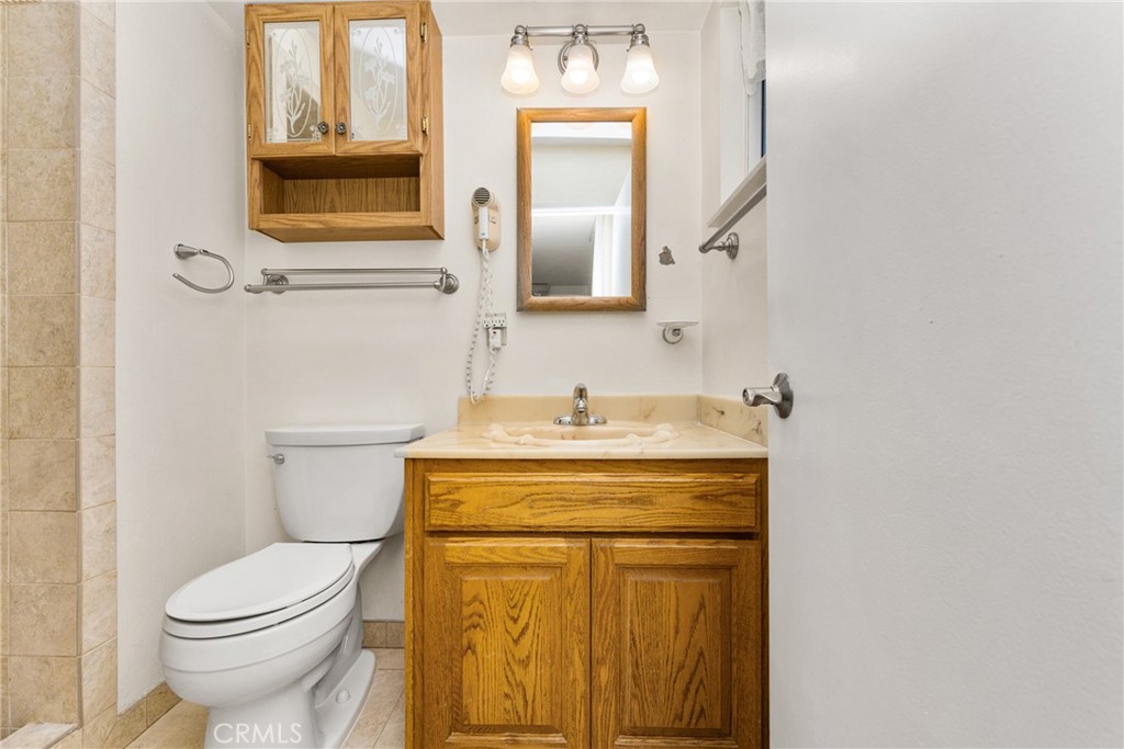 3288 Arizona Lane Costa Mesa, CA 92626 - Photo 25 of 33 a bathroom with a toilet sink and mirror
