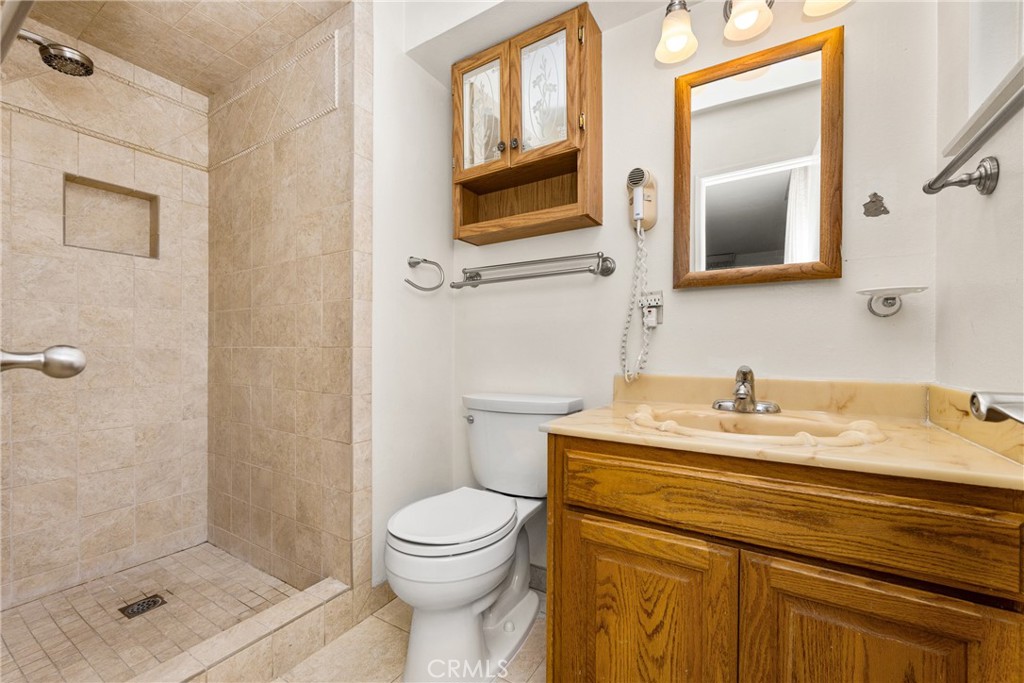 3288 Arizona Lane Costa Mesa, CA 92626 - Photo 26 of 33 a bathroom with a granite countertop toilet sink and mirror