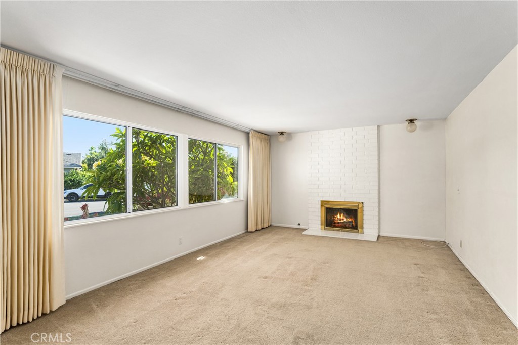 3288 Arizona Lane Costa Mesa, CA 92626 - Photo 6 of 33 an empty room with windows and a fireplace