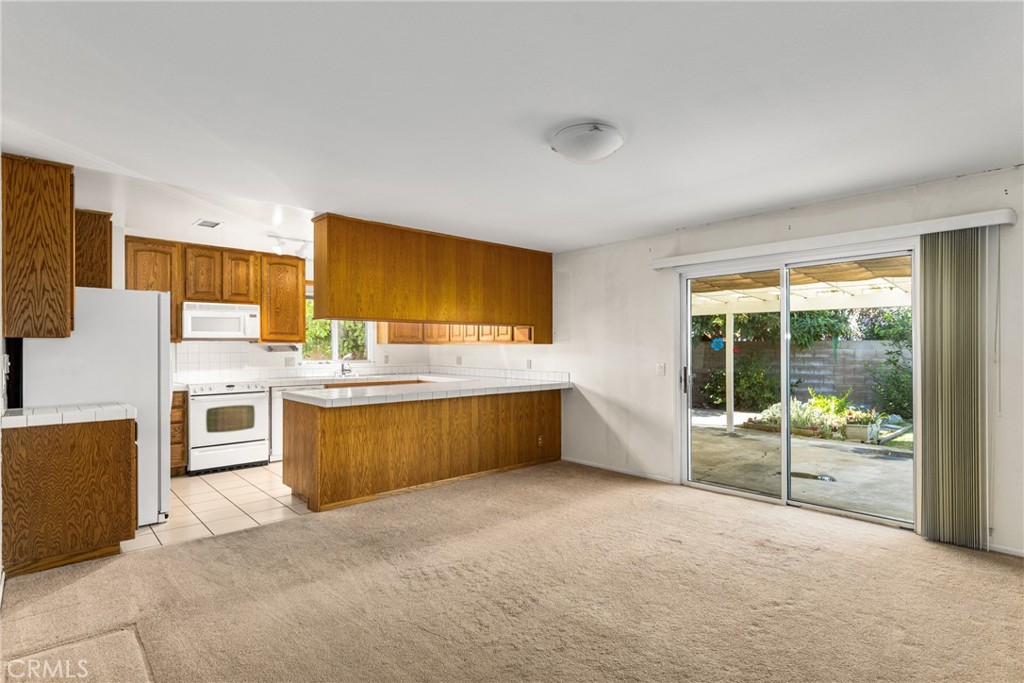 3288 Arizona Lane Costa Mesa, CA 92626 - Photo 9 of 33 a kitchen with stainless steel appliances wooden cabinets and mountain view