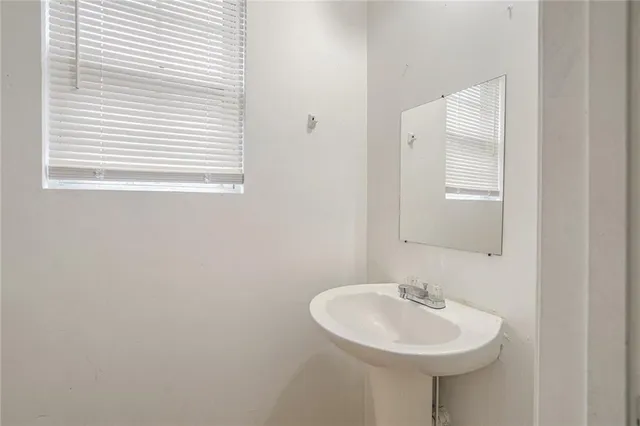 a bathroom with a sink a mirror and a bathtub