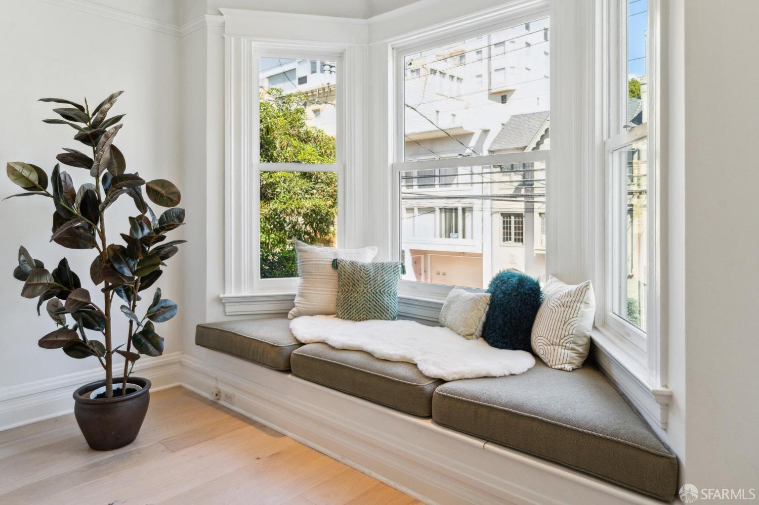 2421 Larkin Street San Francisco, CA 94109 - Photo 17 of 29 a bedroom with a large bed and a potted plant