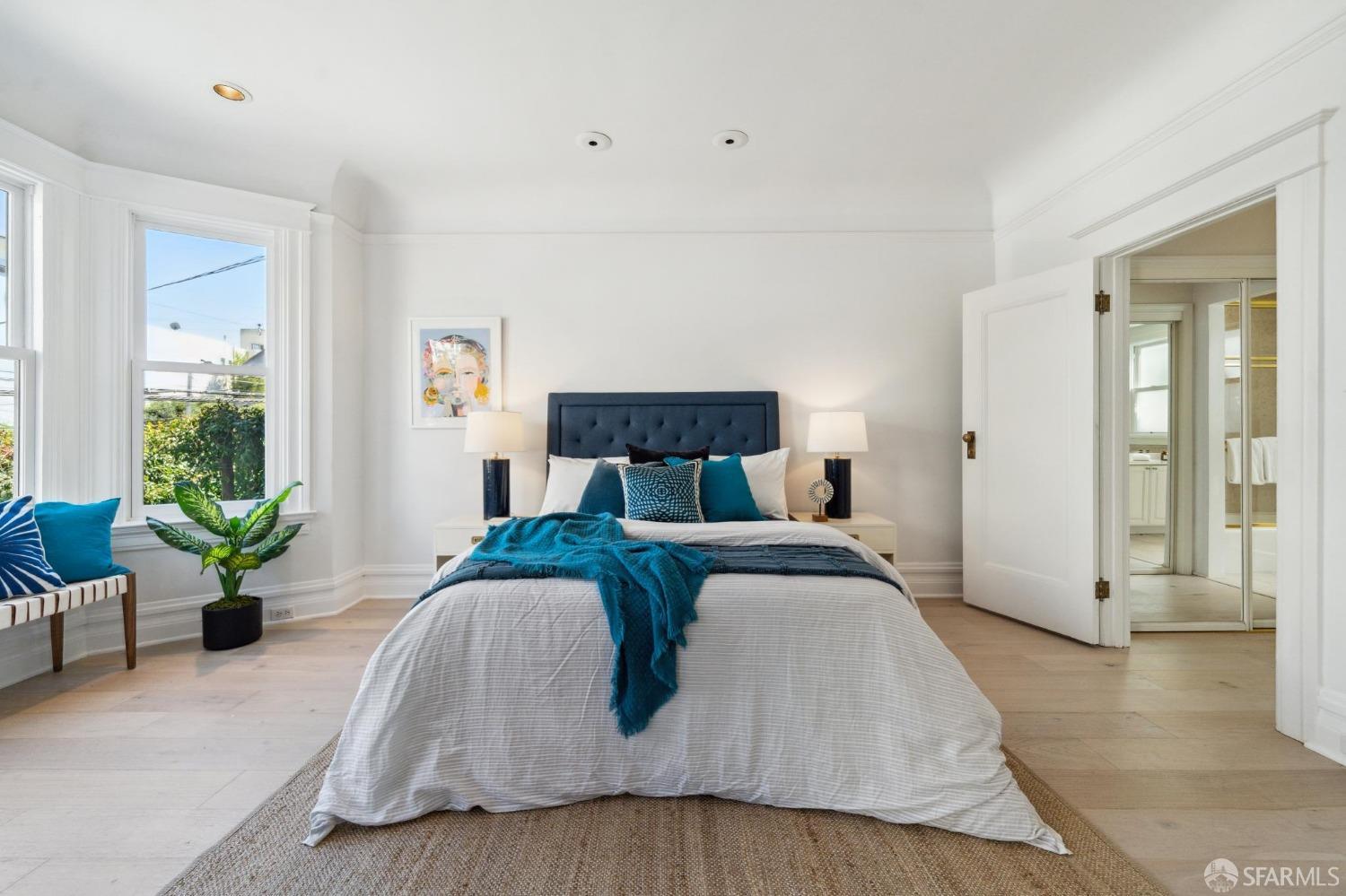 2421 Larkin Street San Francisco, CA 94109 - Photo 18 of 29 a bedroom with a large bed and windows