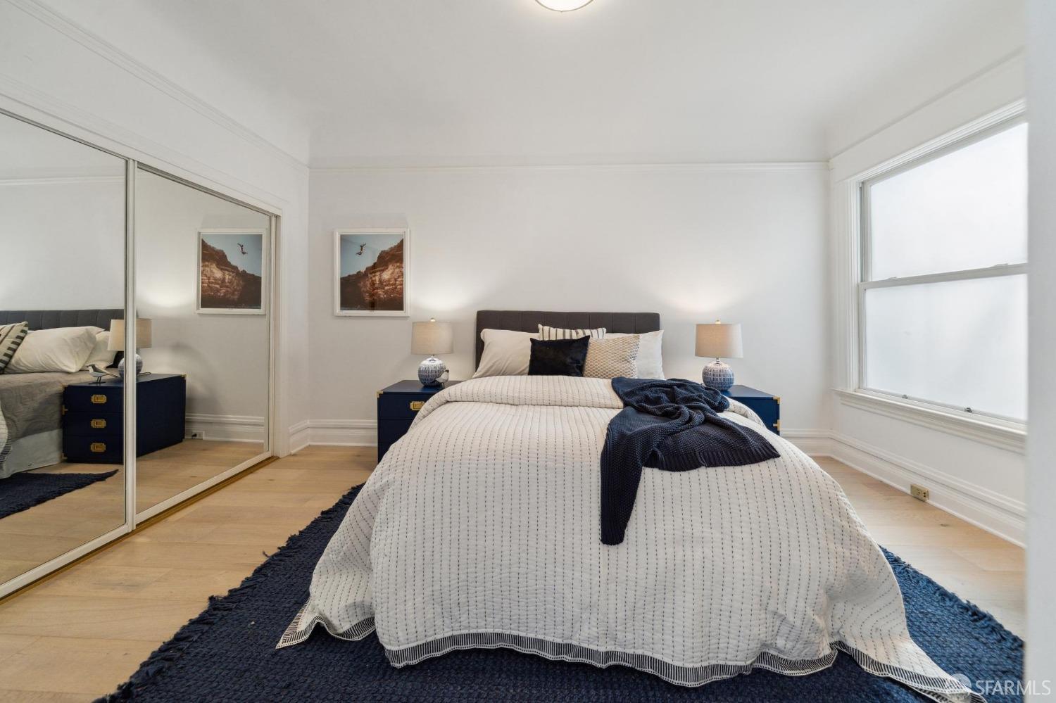 2421 Larkin Street San Francisco, CA 94109 - Photo 23 of 29 a bedroom with a bed and wooden floor