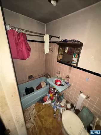 a bathroom with a sink a toilet and shower curtain