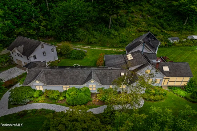 an aerial view of a house with garden space and street view