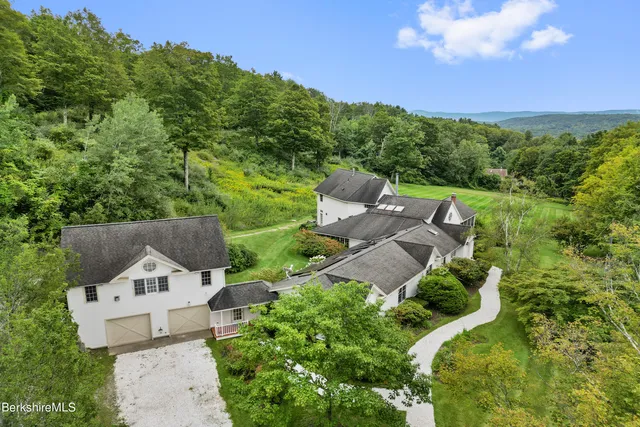 a yard with swimming pool and green space