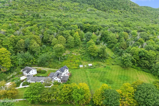 an aerial view of a house with a yard