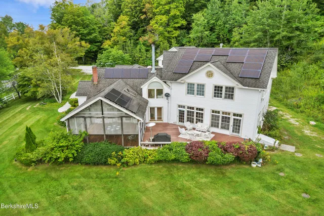 an aerial view of a house with garden space and street view