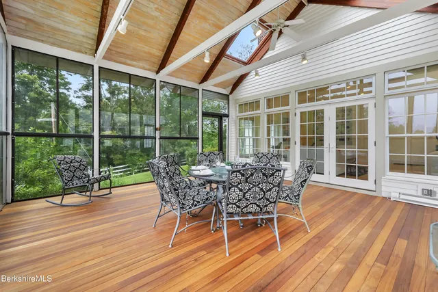 a dining room with furniture a chandelier and wooden floor
