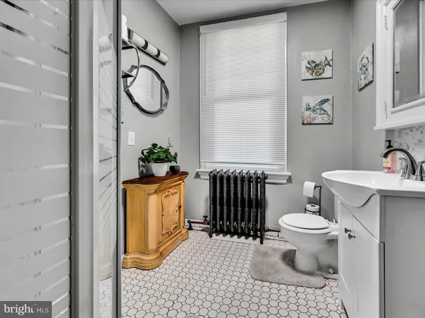 a bathroom with a toilet and a shower curtain