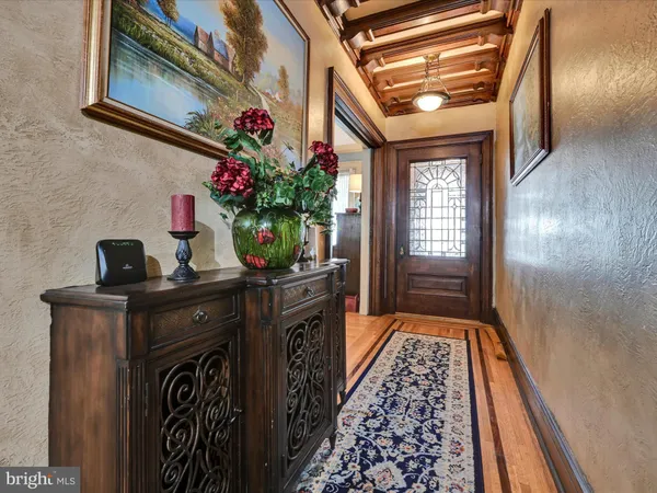 a view of entryway and hall with wooden floor