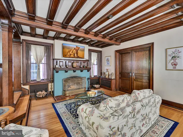 a kitchen with stainless steel appliances granite countertop a sink a stove a refrigerator a dining table and chairs