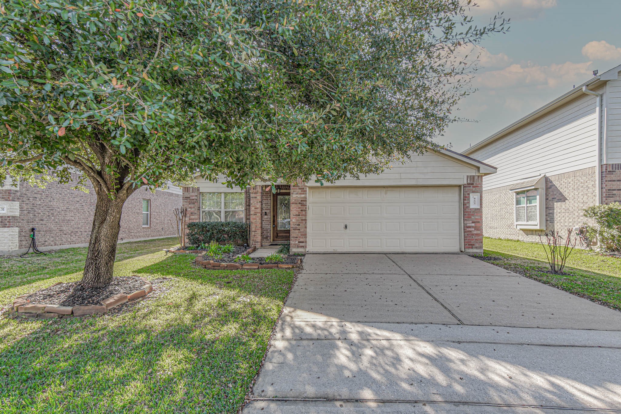 8203 Nagy Hill Street Spring, TX 77379 - Photo 2 of 21 a front view of a house with garden