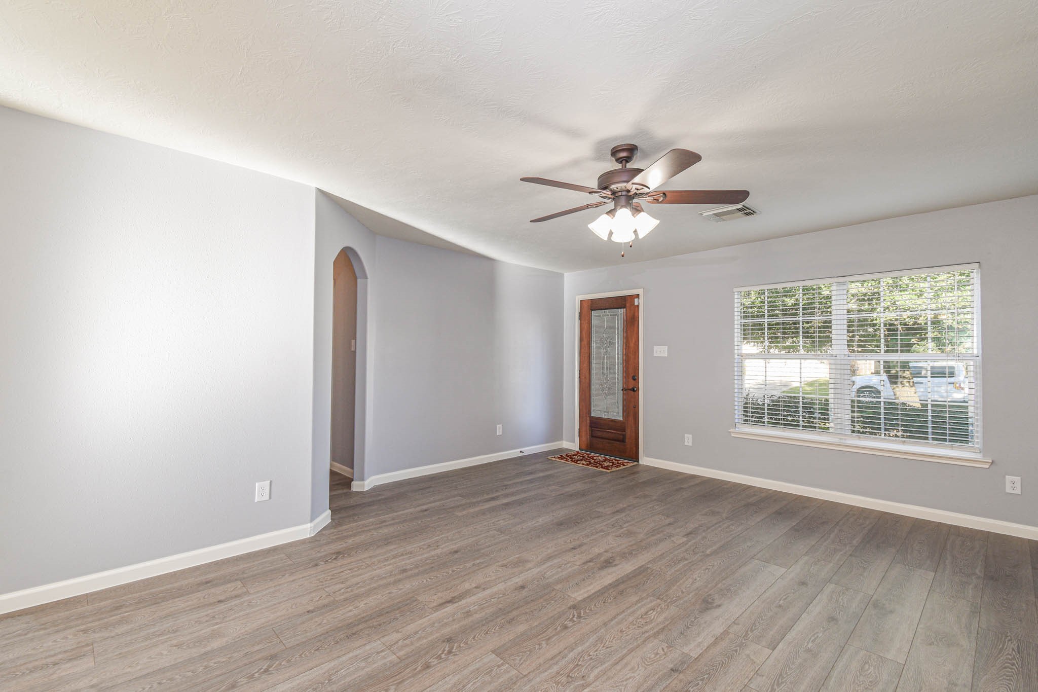 8203 Nagy Hill Street Spring, TX 77379 - Photo 3 of 21 a view of an empty room with window and wooden floor