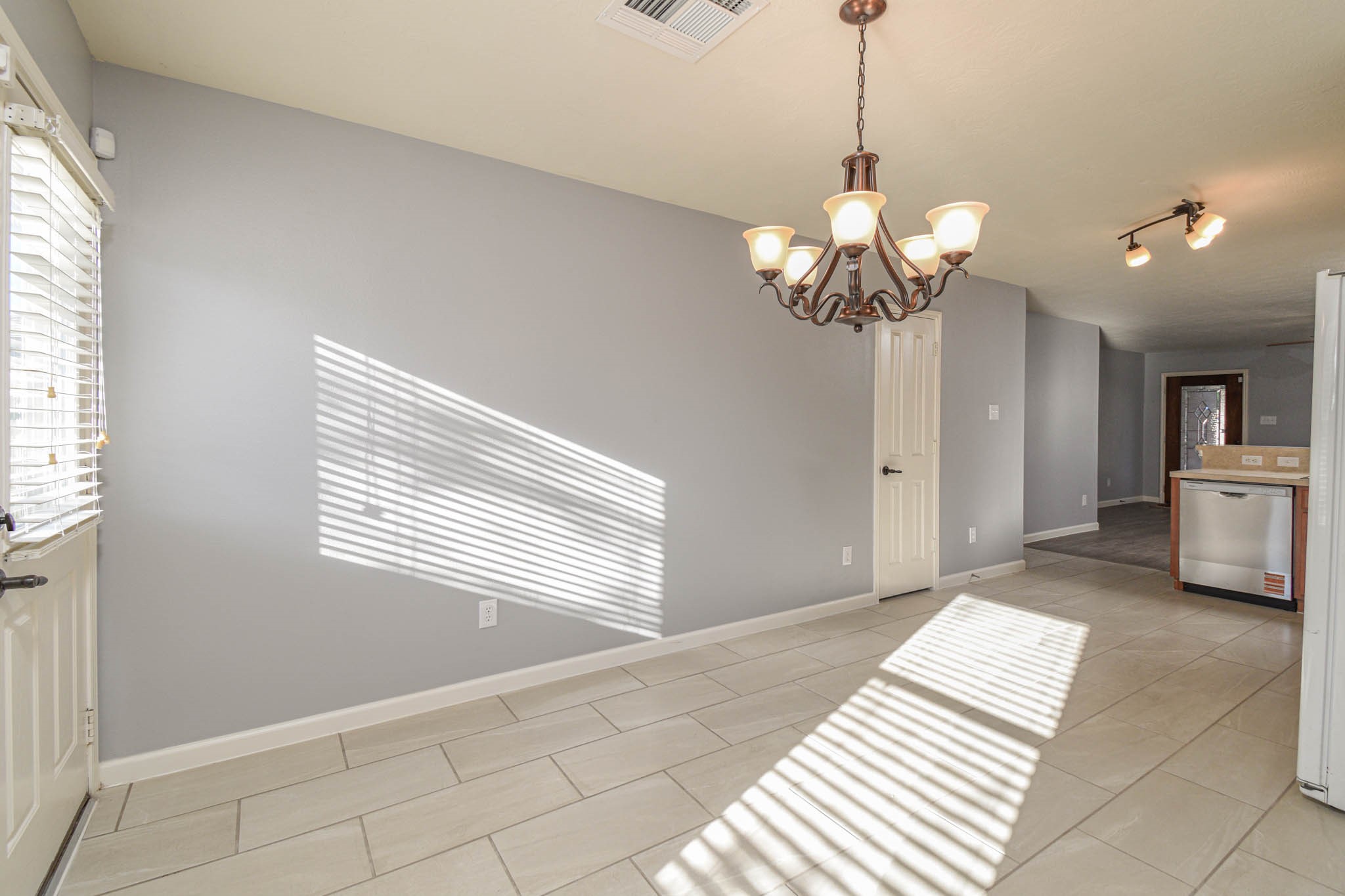 8203 Nagy Hill Street Spring, TX 77379 - Photo 6 of 21 a view of a room with a chandelier fan and windows
