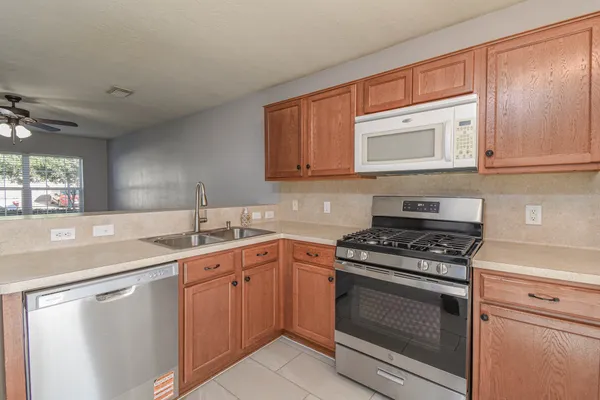 a kitchen with a stove sink and cabinets