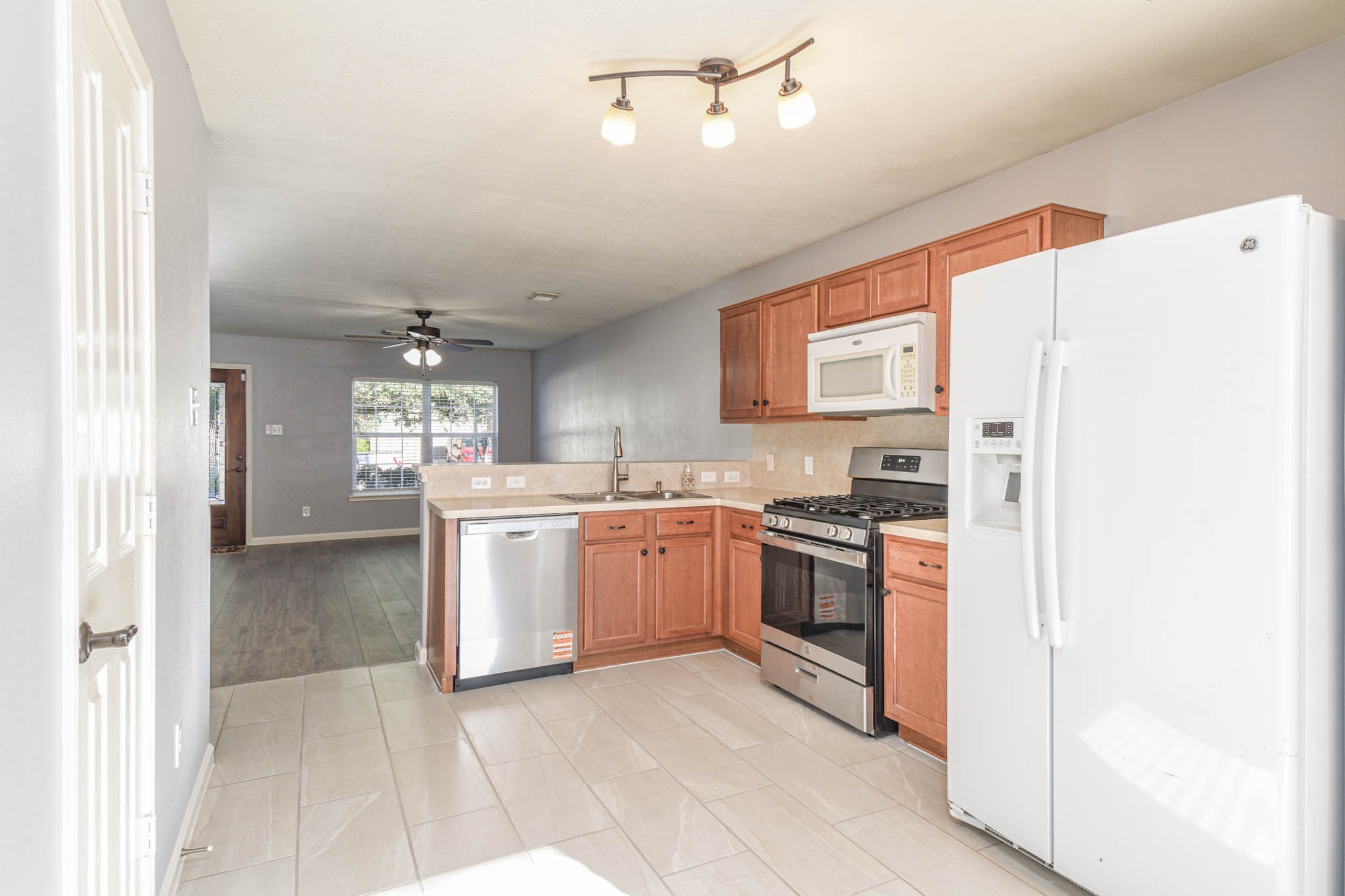 8203 Nagy Hill Street Spring, TX 77379 - Photo 10 of 21 a kitchen with a refrigerator a stove top oven and cabinets