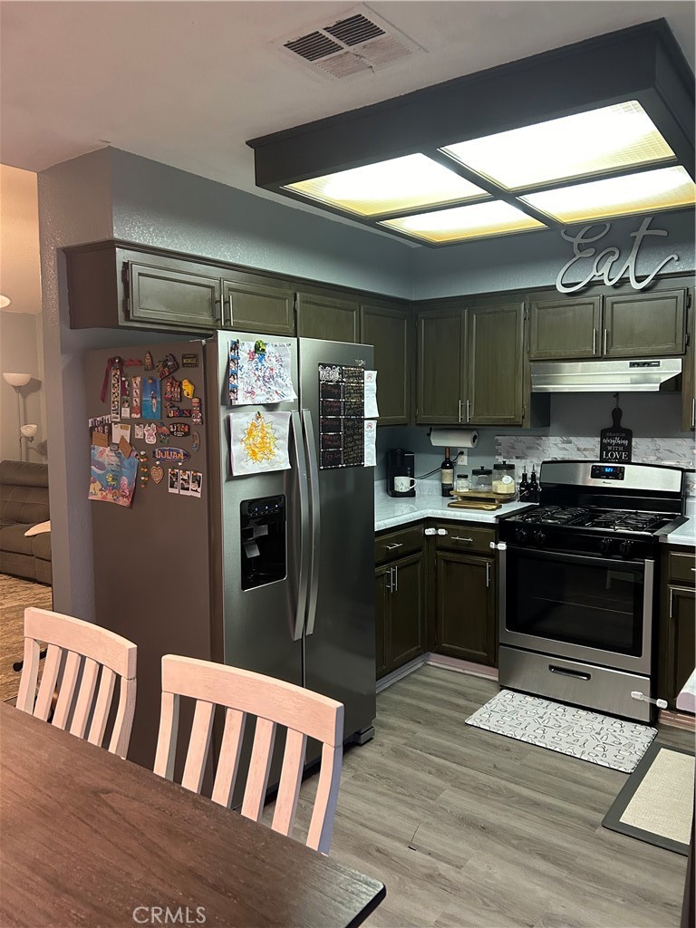 515 Monique Street Merced, CA 95341 - Photo 14 of 22 a kitchen with granite countertop a refrigerator and a stove