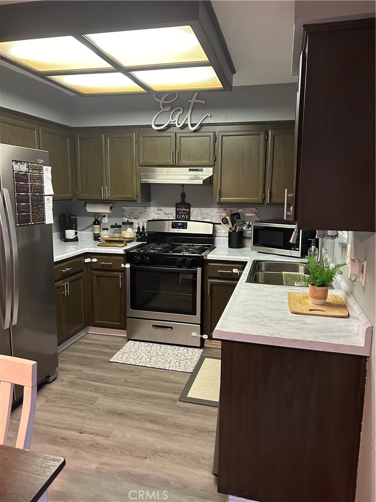 515 Monique Street Merced, CA 95341 - Photo 15 of 22 a kitchen with stainless steel appliances kitchen island granite countertop a sink stove and refrigerator