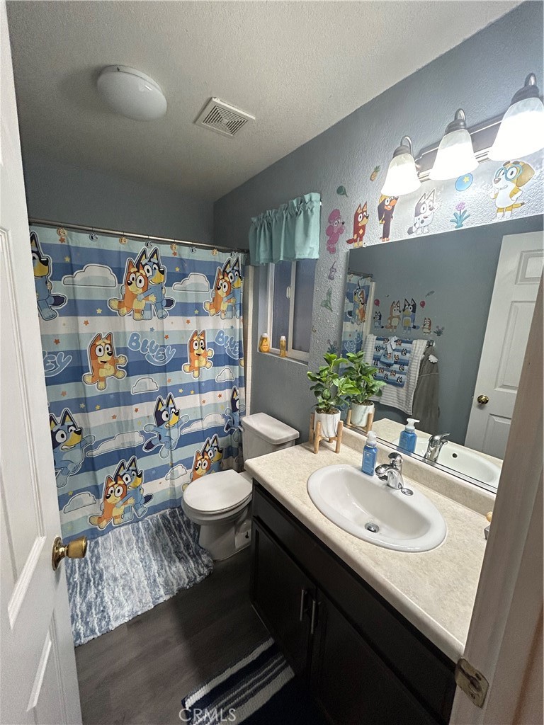 515 Monique Street Merced, CA 95341 - Photo 3 of 22 a bathroom with a sink a toilet and a mirror