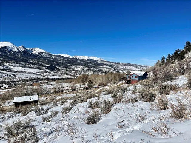 a view of a dry yard with mountains in the background