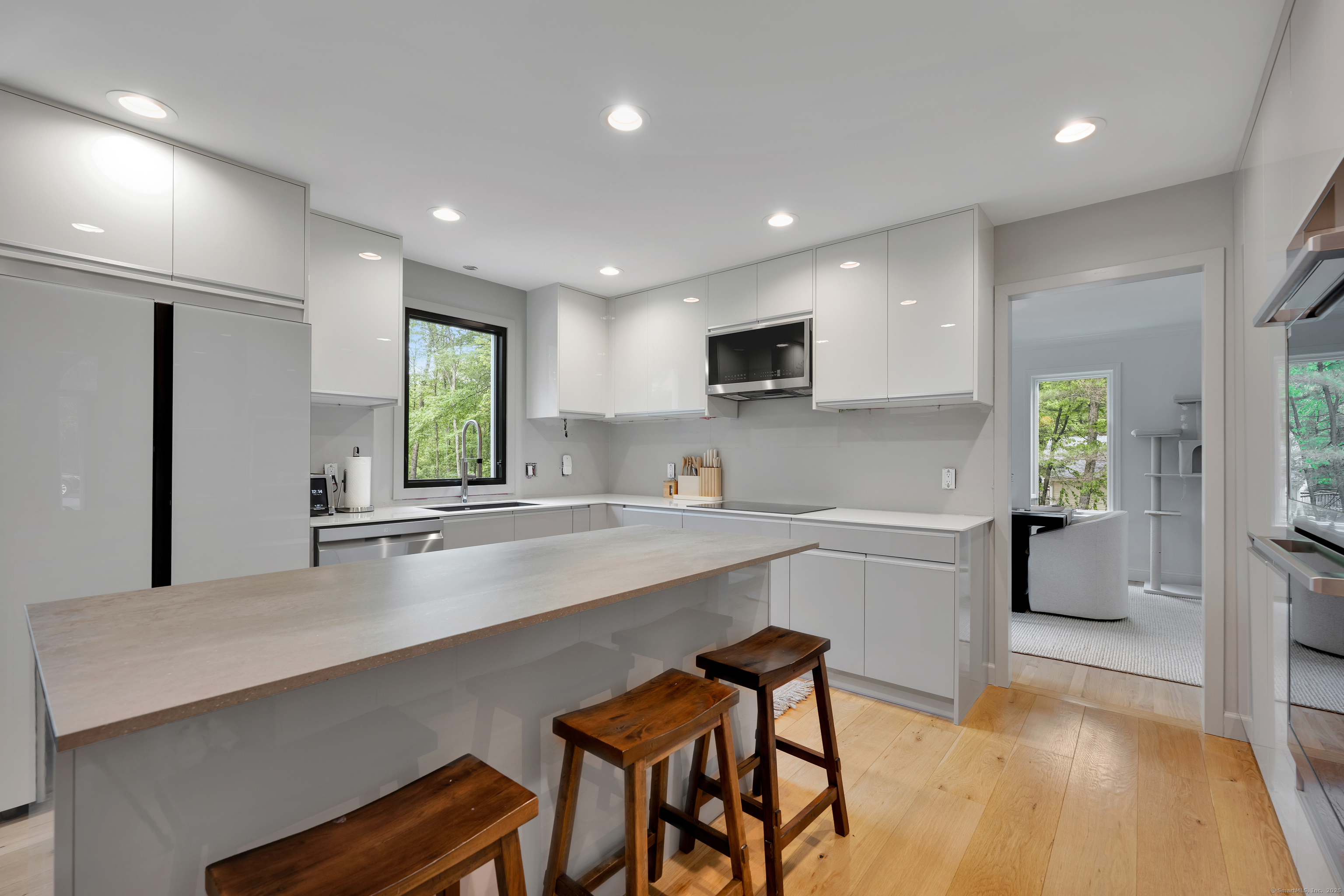 60 Wildcat Road Burlington, CT 06013 - Photo 12 of 39 a large white kitchen with a table and chairs in it