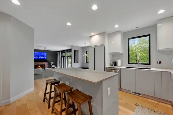 a kitchen with stainless steel appliances granite countertop a sink and a stove top oven