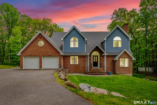 a front view of a house with a yard and garage
