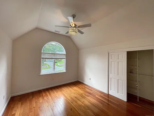 a spacious bedroom with a bed and a desk