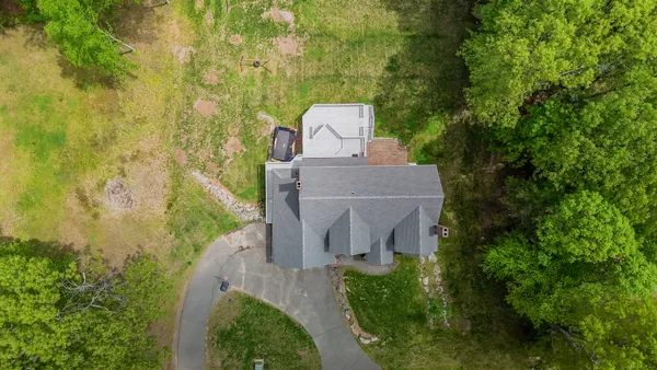 an aerial view of a house with a yard