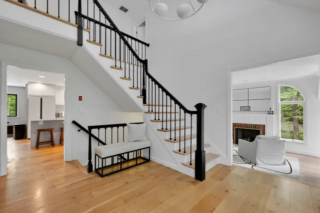 a view of entryway livingroom and hall with wooden floor