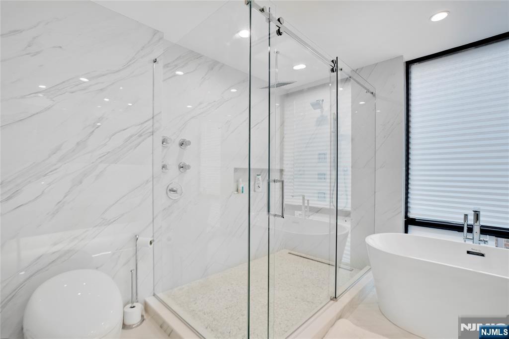 7 Adelaide Place Edgewater, NJ 07020 - Photo 13 of 24 a bathroom with a sink a toilet and shower