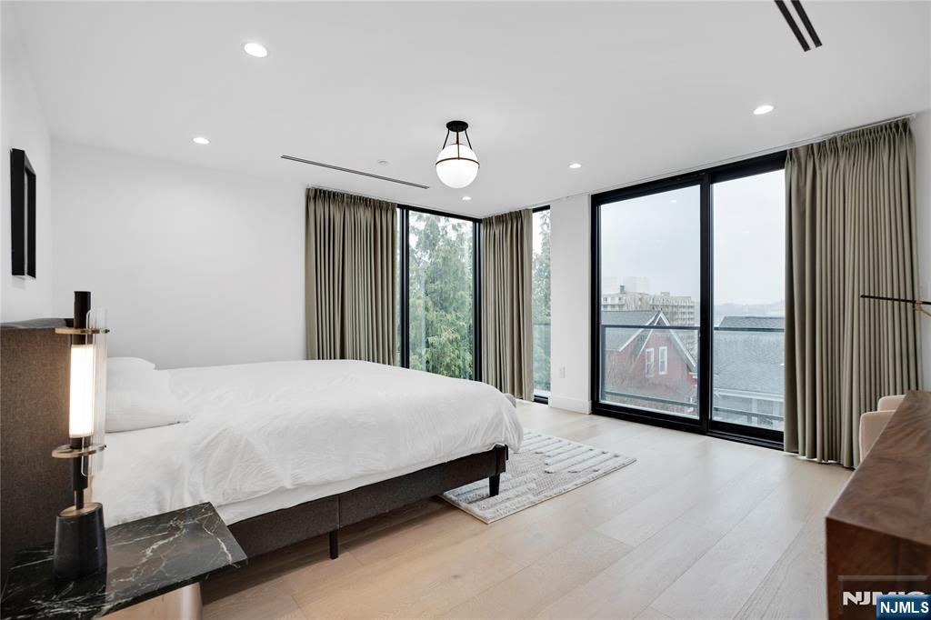 7 Adelaide Place Edgewater, NJ 07020 - Photo 15 of 24 a bedroom with a large bed and a large window