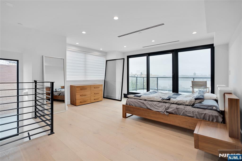 7 Adelaide Place Edgewater, NJ 07020 - Photo 20 of 24 a spacious bedroom with a bed and large window