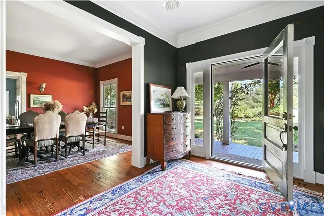 a dining room with furniture and wooden floor