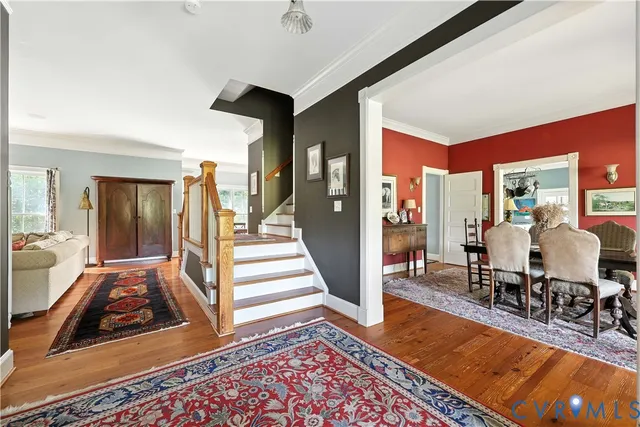 a living room with furniture a large window and a fireplace