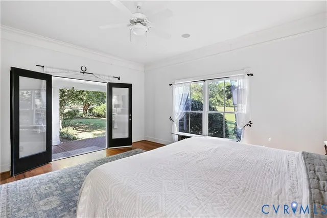 a bed sitting in a spacious bedroom next to a window