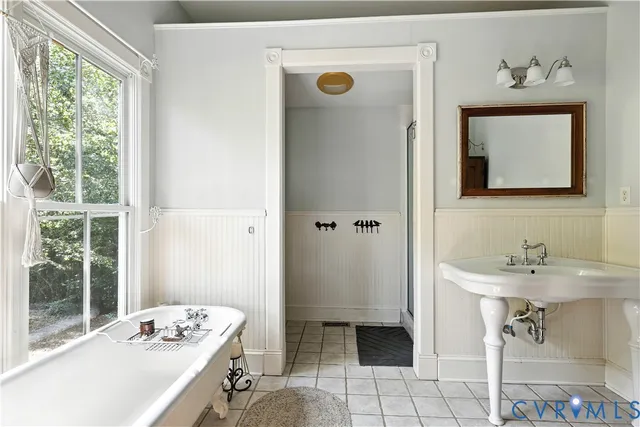 a bath tub sitting in a bathroom next to a window