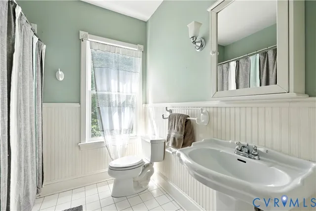 a view of a room with wooden floor and a window