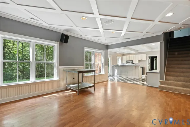 a living room with a fireplace furniture a ceiling fan and a rug
